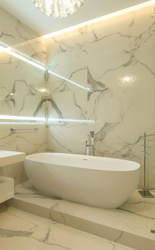 White marble tiled bathroom in Swansea with a clean, elegant finish.